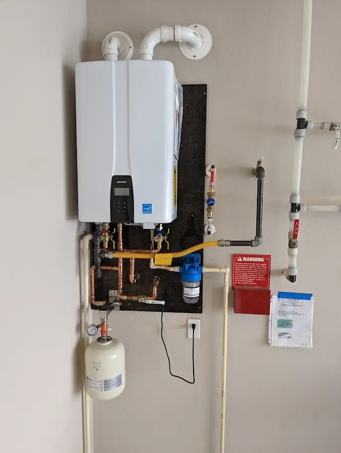 Professional plumber installing copper piping in a East Rutherford home